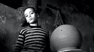 Mohamed Fathy, Egypt: This photo was taken in Souq Al Fakhareen – The Pottery Market in the Old City in Cairo, where a child is seen posing in a shop selling pottery ornaments.