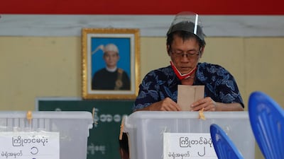 An elderly man casts his ballot during early voting at a polling station in Yangon. EPA