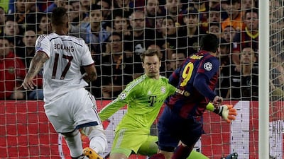 Bayern Munich keeper Manuel Neuer stops a shot from Barcelona's Luis Suarez in the first half of their Champions League semi-final first leg match on Wednesday. Alberto Estevez / EPA
