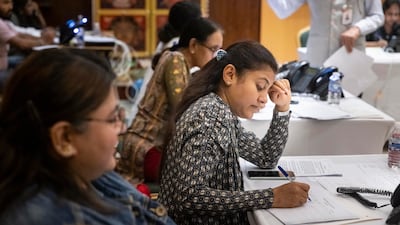 Volunteers work at a hotline centre at the Indian consulate in Dubai. Antonie Robertson / The National