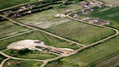 An aerial photo of the beginning of a subdivision for permanent homes in McKenzie county near North Dakota’s badlands. Charles Rex Arbogast / AP Photo