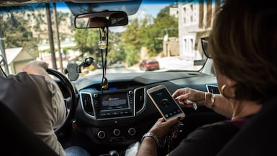Ms Comair contacts a patient to organise dropping off medicine later in the day as she drives to the home of her cousin, whose father regularly receives medicine from her clinic.