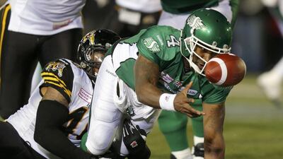 Darian Durant hands off as he is brought down by Hamilton Tiger-Cats Eric Norwood. Todd Korol / Reuters