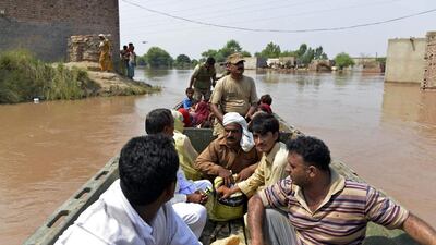 Pakistani soldiers use a boat to rescue residents affected by flooding in Sher Shah, a town in Multan District in Punjab province, on Saturday. The floods began in Kashmir after heavy monsoon rains and are now progressing downstream through Pakistan, inundating thousands of villages and large areas of important farmland in the country's breadbasket. Arif ALI / AFP
