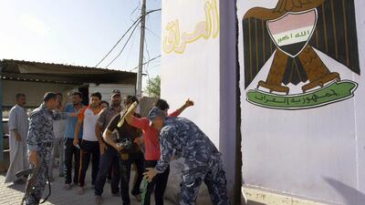 Iraqi security search men as they arrive to volunteer to join the fight against Islamist militants in the central Shiite Muslim shrine city of Najaf on June 12, 2104. Haidar Hamdani / AFP