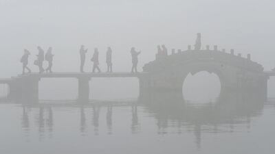 People walk on a bridge amid heavy smog in Hangzhou, Zhejiang province, China. Reuters