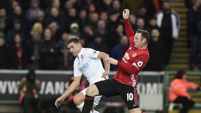 Manchester United's Wayne Rooney, right, in action with Swansea City's Angel Rangel on Sunday, November 6. Rebecca Naden / Reuters