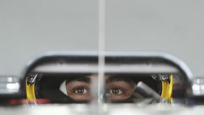 McLaren driver Fernando Alonso of Spain waits in his car at his garage during the third practice session for the Japanese Formula One Grand Prix at the Suzuka International Circuit in Suzuka, central Japan. Eugene Hoshiko / AP Photo