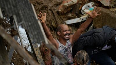 A resident yells during the search for survivors. AP