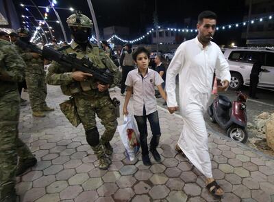 Iraqi security forces carry their weapons in the streets during a security patrol in Basra. Reuters