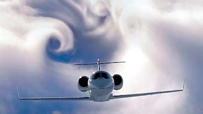 A jet skims above the top of a dense cloud layer creating wingtip vortices. The swirling clouds are created by the air flowing from below the wing, out around the edge to the top of the wing in a circular motion. Paul Bowen / Corbis