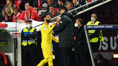 Liverpool's Mohamed Salah greets manager Jurgen Klopp as he leaves the field. PA