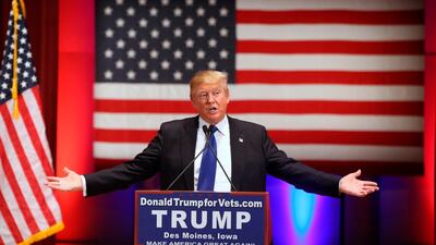 Donald Trump speaks behind a DonaldTrumpforVets.com sign at a fundraising event on January 28, 2016 at Drake University in Des Moines, Iowa during his campaign for president. Andrew Harnik / AP Photo