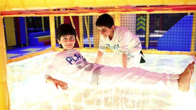 Brothers Mansour and Hammad have fun in the Wizz Works area of Fun Works at Yas Mall. Lee Hoagland / The National