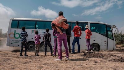 People look at buses carrying relatives of victims of the ET302 flight. AFP