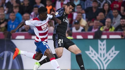 Real Madrid’s Alvaro Morata, right, duels for the ball against Granada’s Martin Hongla. Daniel Tejedor / AP Photo