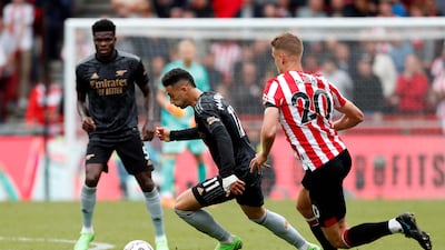 Brentford's Kristoffer Ajer breaks away from Arsenal's Gabriel Martinelli. AFP