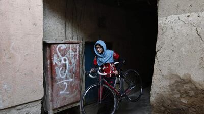 Masooma Alizada, walks with her bicycle in Kabul. Mohammad Ismail / Reuters