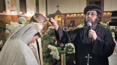 In this 2010 photo, a Coptic priest weds a couple at the Virgin Mary Coptic Church on the island of Zamalek in Cairo, Egypt. Ben Curtis/AP Photo