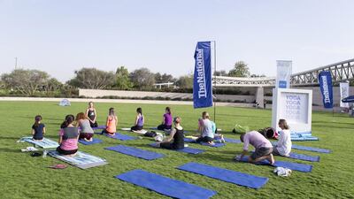 Attendees take part in outdoor yoga at The National Picnic in Umm Al Emarat Park.