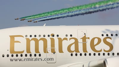 The Emirati Al Fursan aerobatic team fly past an Emirates A380 during the Dubai Airshow in 2013. Getty Images