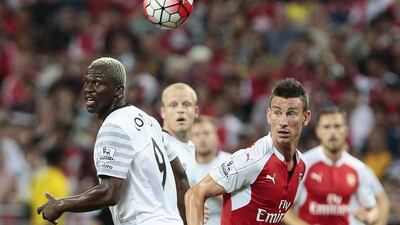 Everton's Arouna Kone and Arsenal's Laurent Koscielny vie for the ball during the final of the pre-season Asia Trophy tournament on Saturday in Singapore. Wallace Woon / EPA