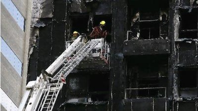 Firefighters inspect Al Baker Tower 4 in Sharjah, which was gutted by a blaze in January.