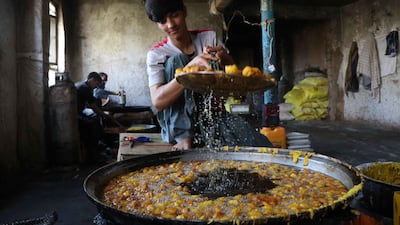 A vendor preparing sweets as time to break the fast approaches, in Herat, Afghanistan. EPA