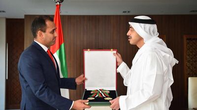 Sheikh Abdullah bin Zayed, Minister of Foreign Affairs and International Cooperation, presents the Order of Independence to Umej Singh Bhatia, the ambassador of Singapore to the UAE. Wam