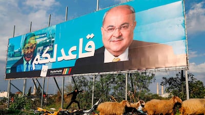 Arab Israeli member of the Joint List Ahmad Tibi on a campaign poster, with the Arabic writing which reads "I am staying seated" in the northern Israeli City of Tayyiba. AFP