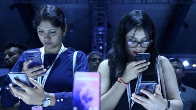Visitors checking the new phones of OnePlus 7 series in Bangalore on Tuesday. EPA