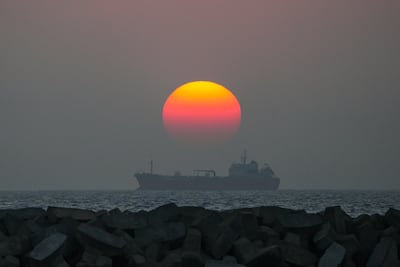 An oil tanker is moving on the sea at sunset in Colombo, Sri Lanka, on January 25, 2024. AFP