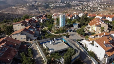 An aerial photo of the Palestinian Gharib family's house, centre, in between Israeli army barriers, which is at the heart of the Jewish settlement of Givon Hahadasha, north of Jerusalem. All photos by AFP