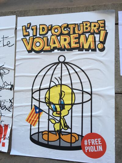 One poster plastered on buildings shows Tweety encaged — presumably by Madrid — but defiantly holding aloft the Catalan flag, known as the Senyera. Richard Ferraris
