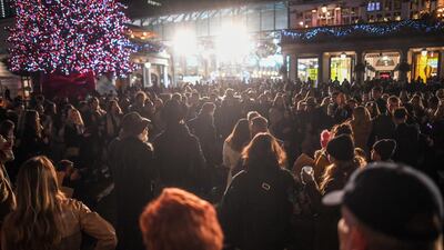 Crowds of people listen to a busker in Covent Garden on December 5, 2020 in London, England. Getty Images