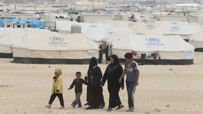 Syrian refugees walk past tents at the Al Zaatri refugee camp in the Jordanian city of Mafraq near the Syrian border. As temperatures drop into the single digits at night, it is the cold that poses the latest threat to their health.