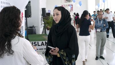 A Chinese delegate talks business with a counterpart. Delores Johnson / The National