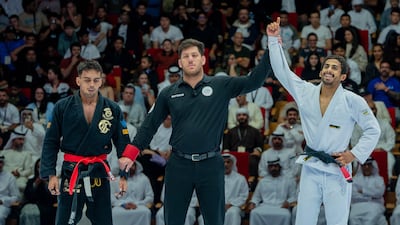 Zayed Al Katheeri's hand is raised as winner. Photo: UAEJJF