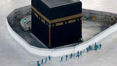 Workers disinfect the ground around the Kaaba, the cubic building at the Grand Mosque, in the Muslim holy city of Makkah. AP