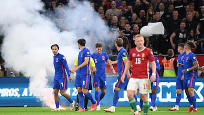England players look towards the crowd after their game against Hungary in Budapest was interrupted by flares landing on the pitch. England players were also the subject of racist abuse. AFP