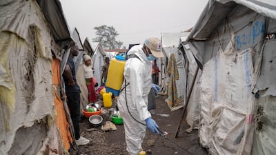A Red Cross worker sprays chlorine at a camp for internally displaced people in Goma, Democratic Republic of Congo. EPA