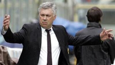 Carlo Ancelotti celebrates after his AC Milan side beat Fiorentina 2-0 in the final game of the Serie A season to guarantee Champions League football next term.