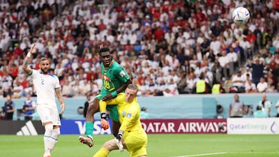 Ismaila Sarr of Senegal shoots past Jordan Pickford of England. Getty