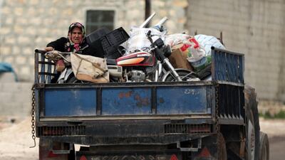 A woman sits on a truck with her belongings after Turkish-backed Free Syrian Army fighters captured Khaldieh village, in eastern Afrin, Syria on March 10, 2018. Khalil Ashawi / Reuters