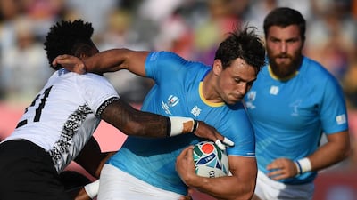 Uruguay wing Nicolas Freitas, second right, is is tackled by Fiji scrum-half Nikola Matawalu during their Rugby World Cup Pool D match. Uruguay pulled off a shock 30-27 victory. AFP