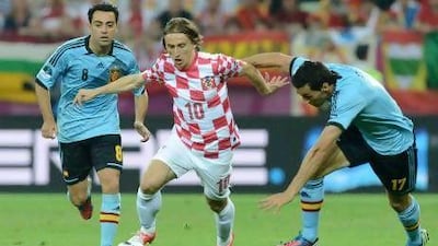 Luka Modric, centre, escapes the attention of two Spanish players during Croatia's Group C match at Euro 2012. Christof Stache / AFP