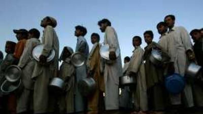 People displaced by the military operation in Swat queue up for a serving of tea at the Yar Hussain camp near Islamabad yesterday.