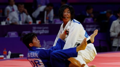 UAE judoka Bishrelt Khorloodoi, right, impressed in women's 52kg division at the 2023 Asian Games in Hangzhou. Reuters