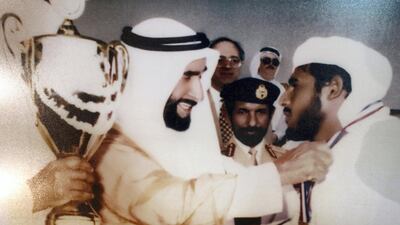 The inside of Ahmed Al Falahi's majlis is decorated with a poster of UAE Founding Father Sheikh Zayed awarding a camel racer a winning prize. Chris Whiteoak / The National