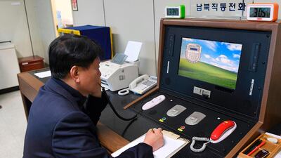 A South Korean government official talks to a North Korean officer during a phone call in 2018 at the border village of Panmunjom in Paju, South Korea.